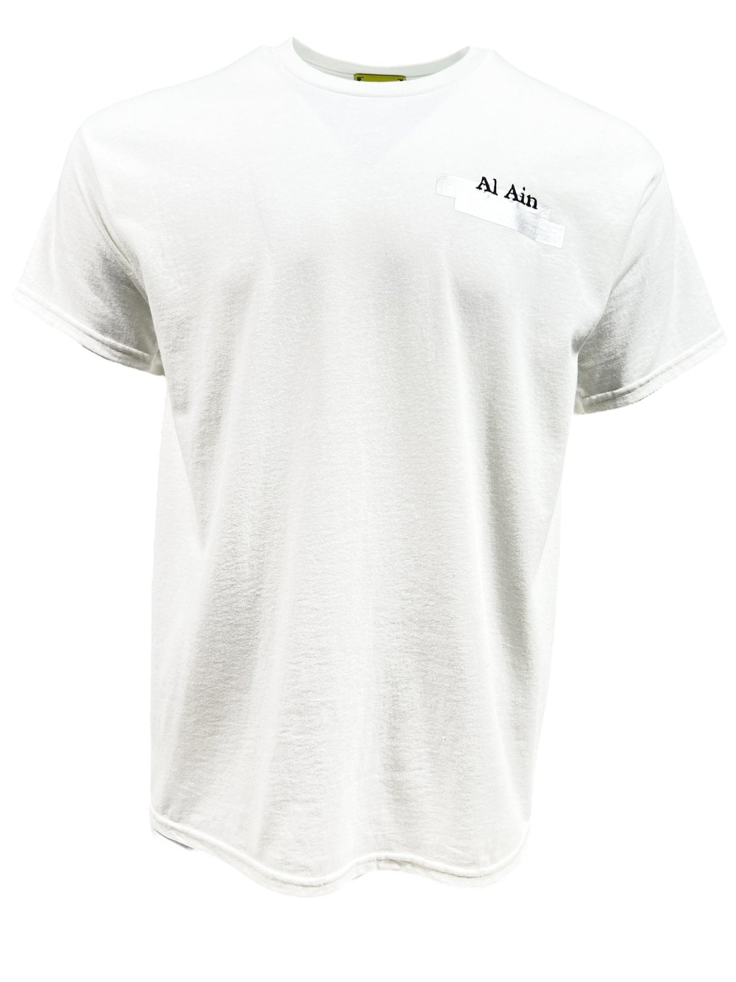 White graphic T-shirt by AL AIN, named "Al Ain AMHX S124 Chill Blanc," showcasing "Al Ain" text embroidered on the upper left chest area, made from 100% cotton, and presented on a plain white background.