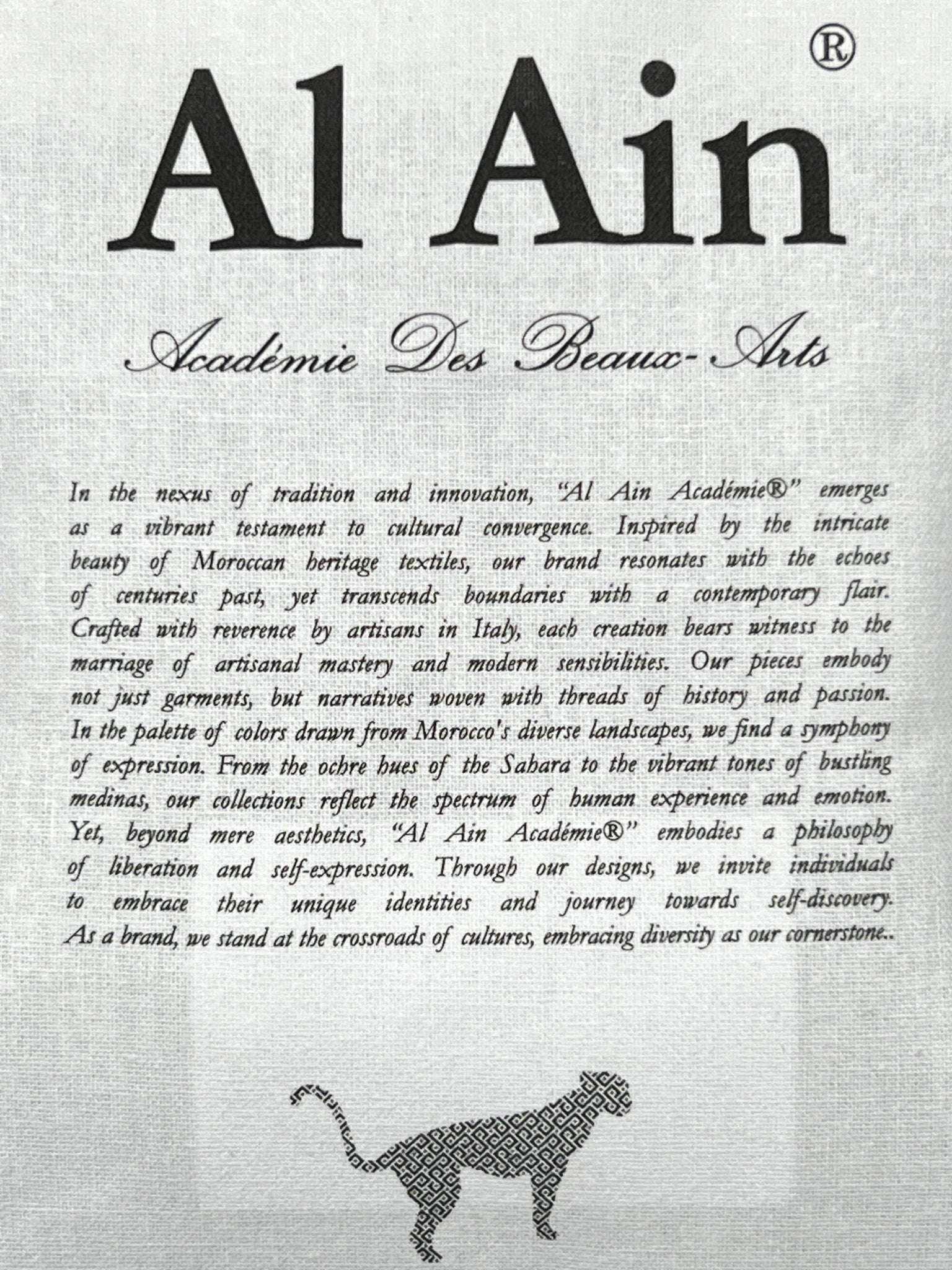 Black text on a gray-textured background highlights Moroccan heritage, artistic values, and a cheetah sketch—printed on the AL AIN Al Ain AMHX-S815 Haj T-shirt White, made from 100% cotton.