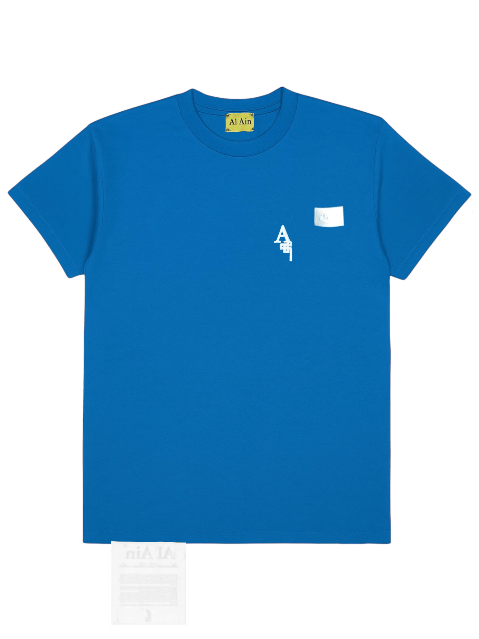 The AL AIN Al Ain AMHX-S818 Majorelle T-shirt Orient is a blue short-sleeve 100% cotton tee with a small white text graphic, left chest patch, and “Al Ain” labeled on the neck tag.