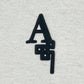 The AL AIN Al Ain AMHX-S821 Makan T-shirt Natural features overlapping black "A" and "S" letters on off-white 100% cotton, made in Italy.