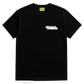The AL AIN Al Ain AMHX-S870 Detruit T-shirt Black is a 100% cotton, Italian-made black short-sleeve tee with a yellow "Al Ain" neck label and a small white graphic on the upper left chest.