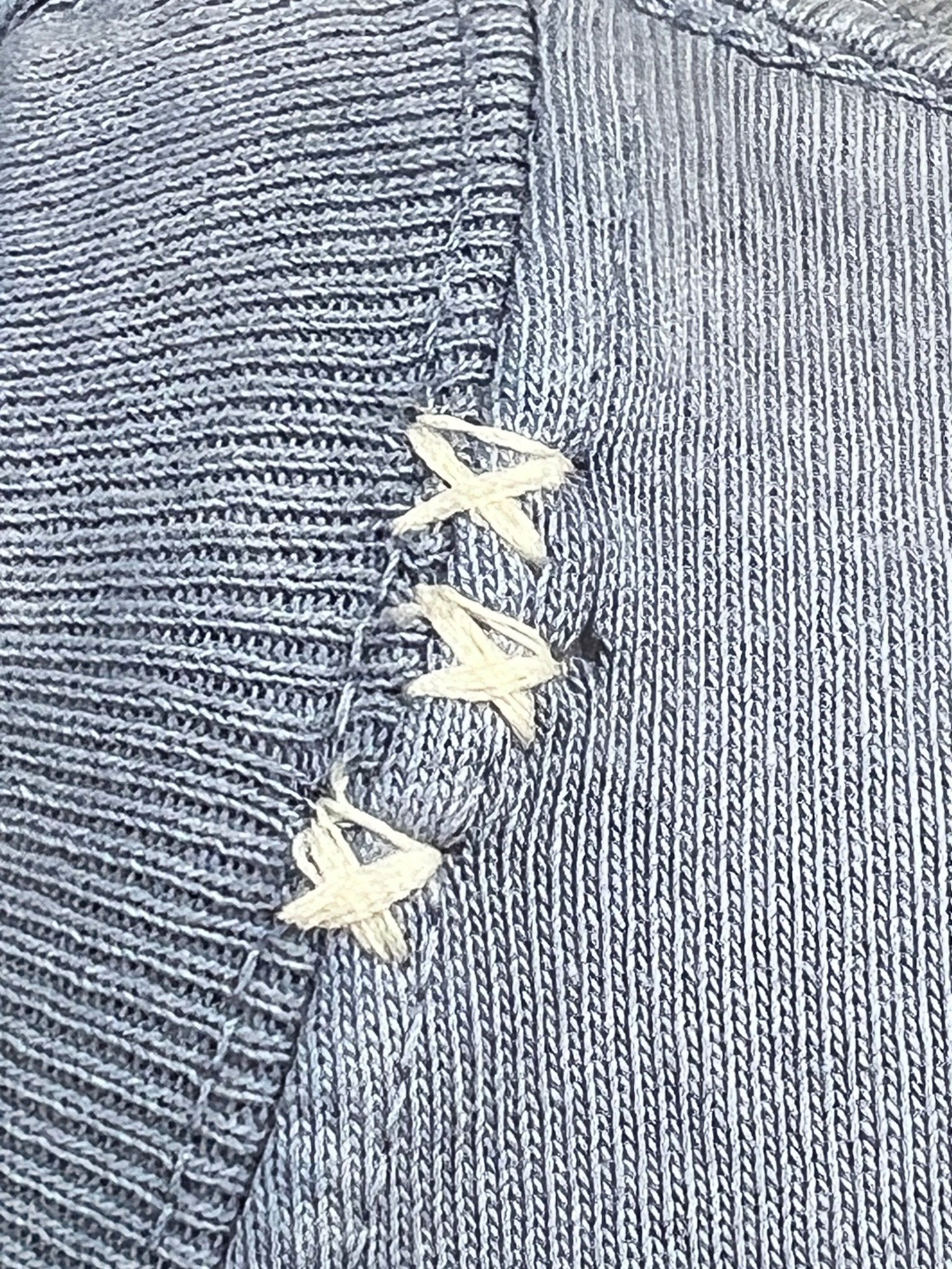 Close-up of the Breeze Blue fabric from the Alchemist All-Seeing Cactus Tee by ALCHEMIST, featuring pronounced white cross-stitching along a seam, evoking a vintage washed aesthetic.