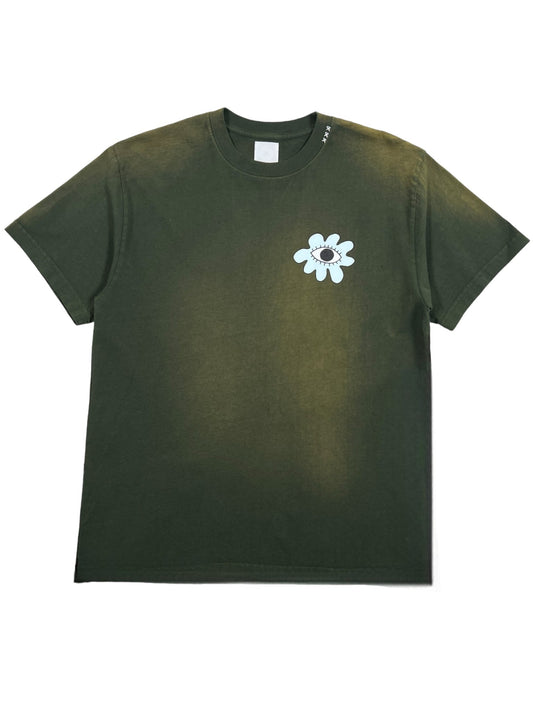 The ALCHEMIST ALL-SEEING FLOWER TEE in moss green is a vintage washed t-shirt made from 100% cotton, featuring a small white flower graphic with an eye in the center on the chest.