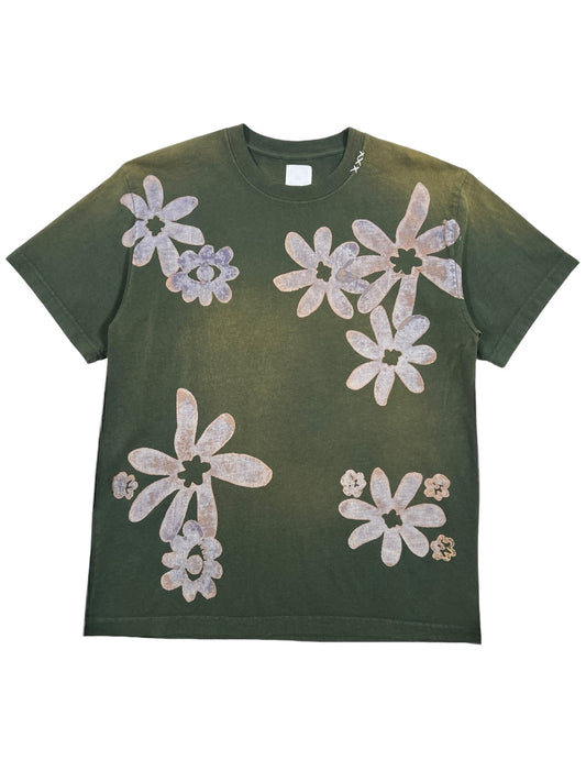 The ALCHEMIST BLOCK PRINT S/S TEE in Moss Green is a vintage-washed graphic t-shirt adorned with large, abstract white flower designs scattered across the front.