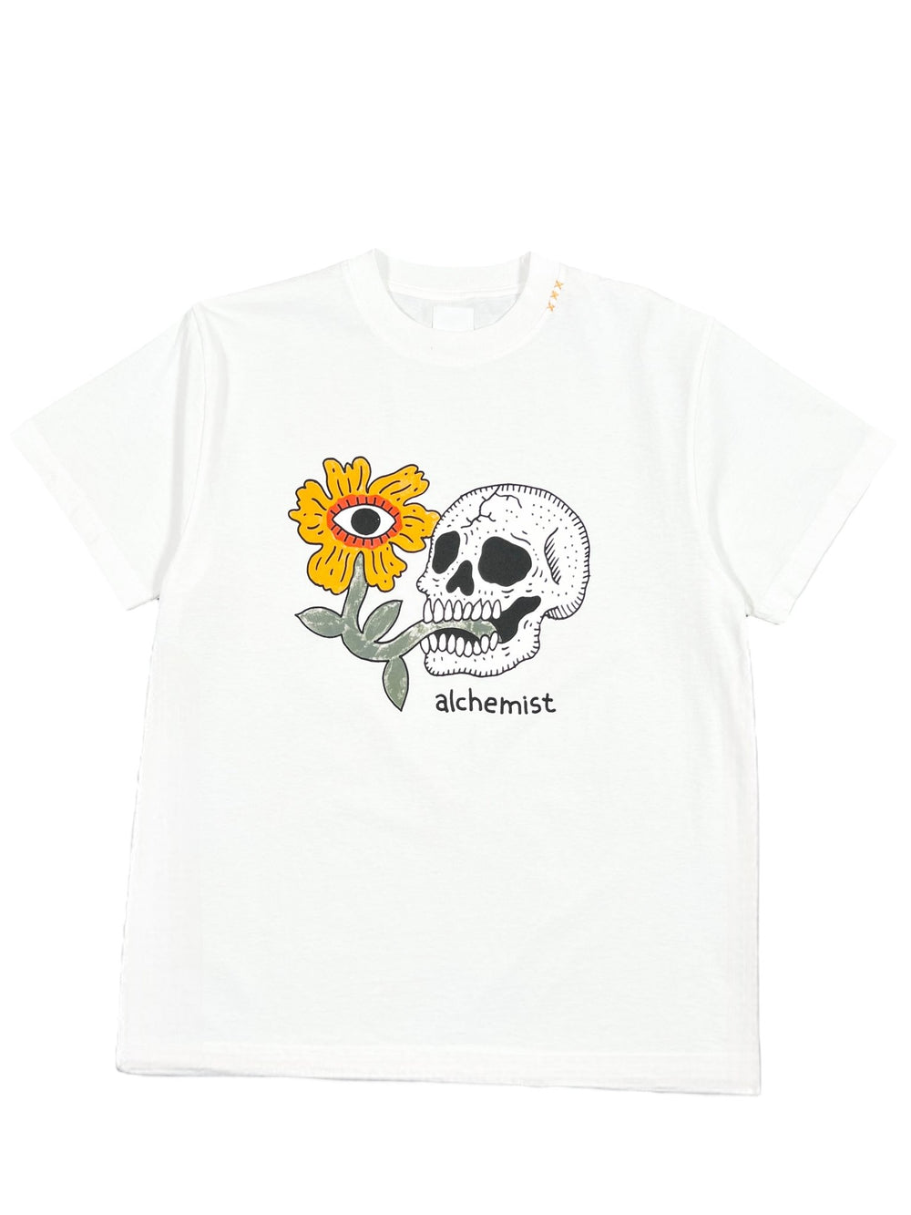 The ALCHEMIST FLORAL SKULL TEE 2 WHITE by ALCHEMIST features a skull, a sunflower with an eye in the center, and the word "ALCHEMIST" below. This vintage washed finish tee exudes unique style.