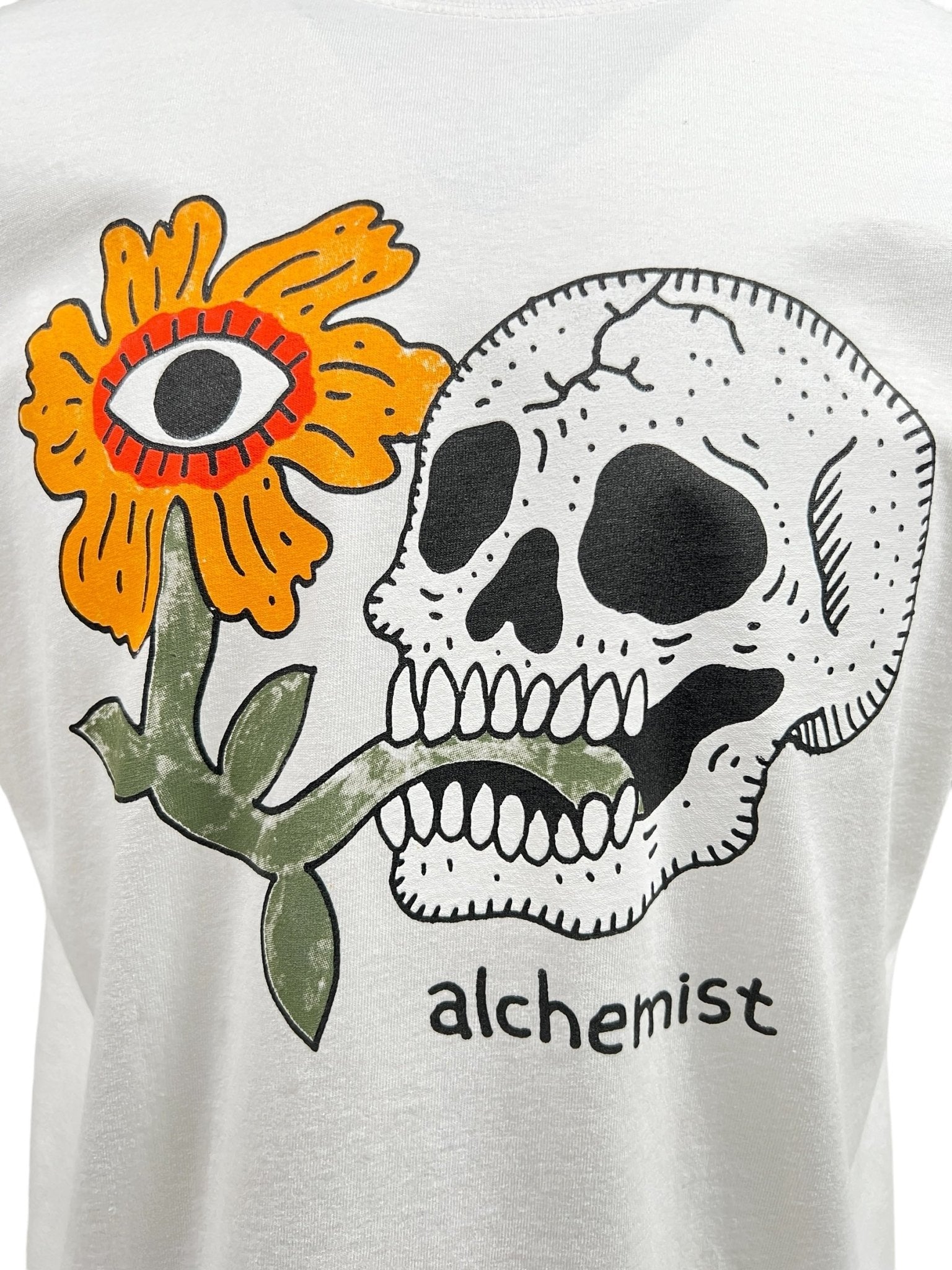 The Alchemist Floral Skull Tee 2 White from ALCHEMIST showcases a bold design featuring a skull and flower, complemented by a vintage washed finish for an effortlessly edgy vibe.