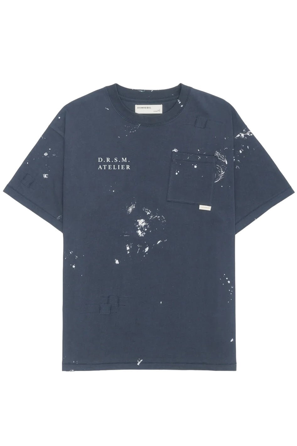 The Domrebel Atelier Pocket Tee in dark blue by DOM REBEL features a white paint splatter design, chest pocket, and "D.R.S.M. Atelier" text, offering an edgy fashion style.