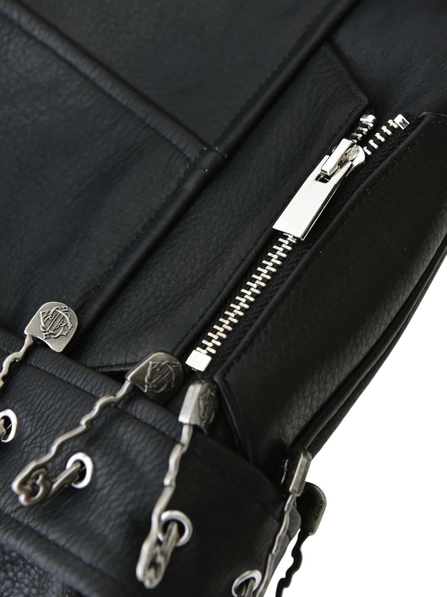 Close-up of the BIRTH OF ROYAL CHILD Birth Of Royal Child BC25SSJK09 Pin Detail Leather Jacket Black, showcasing premium leather, a silver zipper, metal eyelets with cords, and textured details for a bold motorcycle-inspired look.