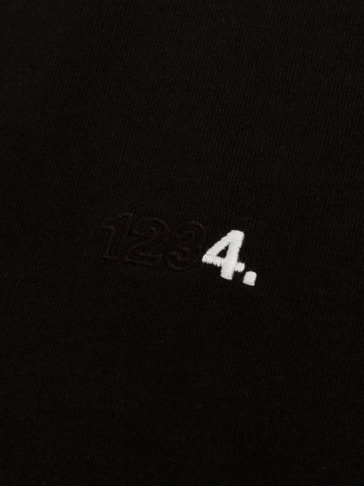 The BLDG4 Polished SS Knit Black tee by BLDG4 is made from 100% cotton and features black "123" and a white "4." embroidered on black fabric.