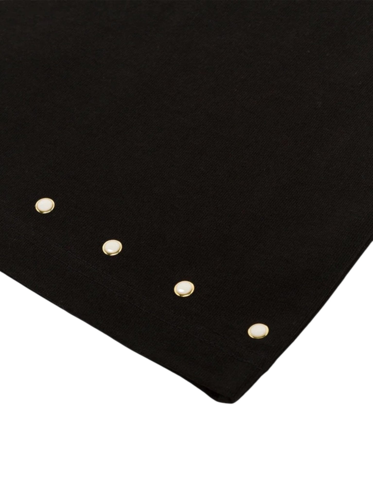 A close-up of the BLDG4 Polished SS Knit Black tee, made from 100% cotton and designed with five evenly spaced round gold pearl rivets along the edge.