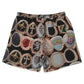 The BLDG4 Smile Short Black by BLDG4 features an all-over print of gemstone rings, portraits, and designs on a black background, plus an adjustable waist for comfort.