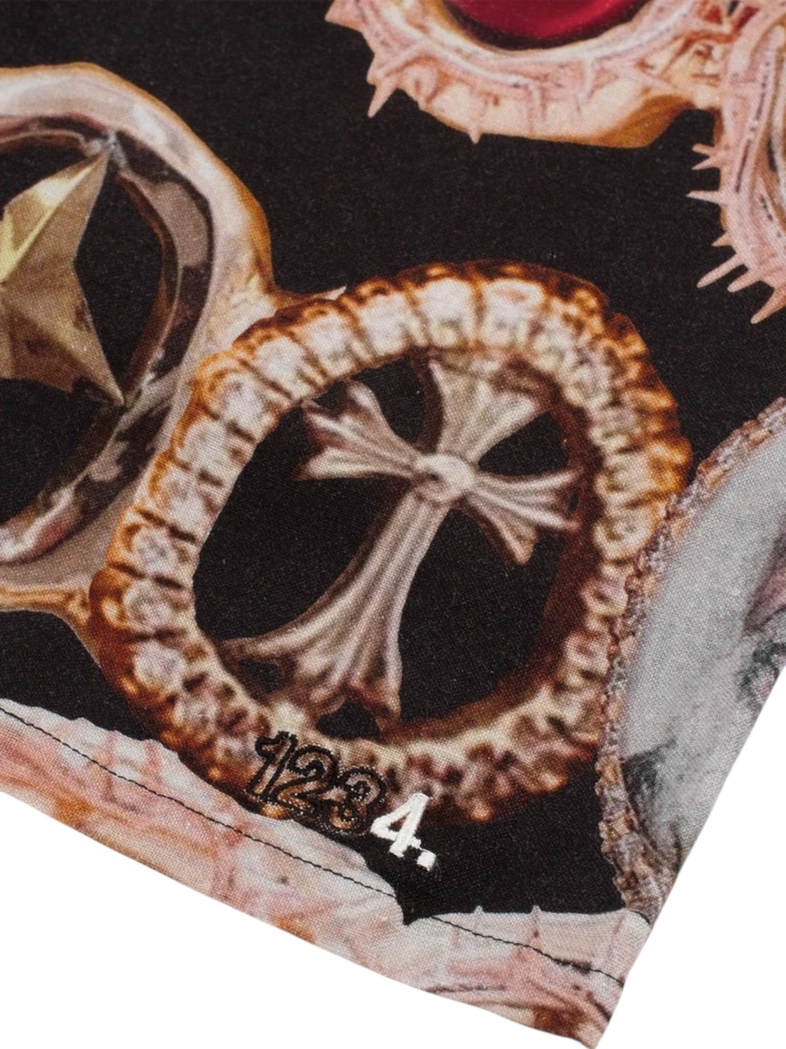 Close-up of the BLDG4 Smile Short Black shows an all-over print fabric with ornate gold rings in various designs—one featuring a cross—and the numbers "1234." at the bottom.