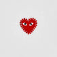 The COMME DES GARCONS X PLAY P1T801 T-Shirt features a white base with a red rhinestone heart adorned with two eyes and a dotted border, inspired by the classic CDG design.