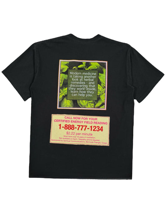 The CRTFD AYURVEDIC T-SHIRT BLACK is a stylish, sustainable piece made from organic cotton. It features a green and yellow design on the back with the text, "Modern medicine is taking another look at herbal discoveries," along with a call-to-action advertisement that includes a phone number and rate. This CRTFD creation merges fashion with eco-consciousness.