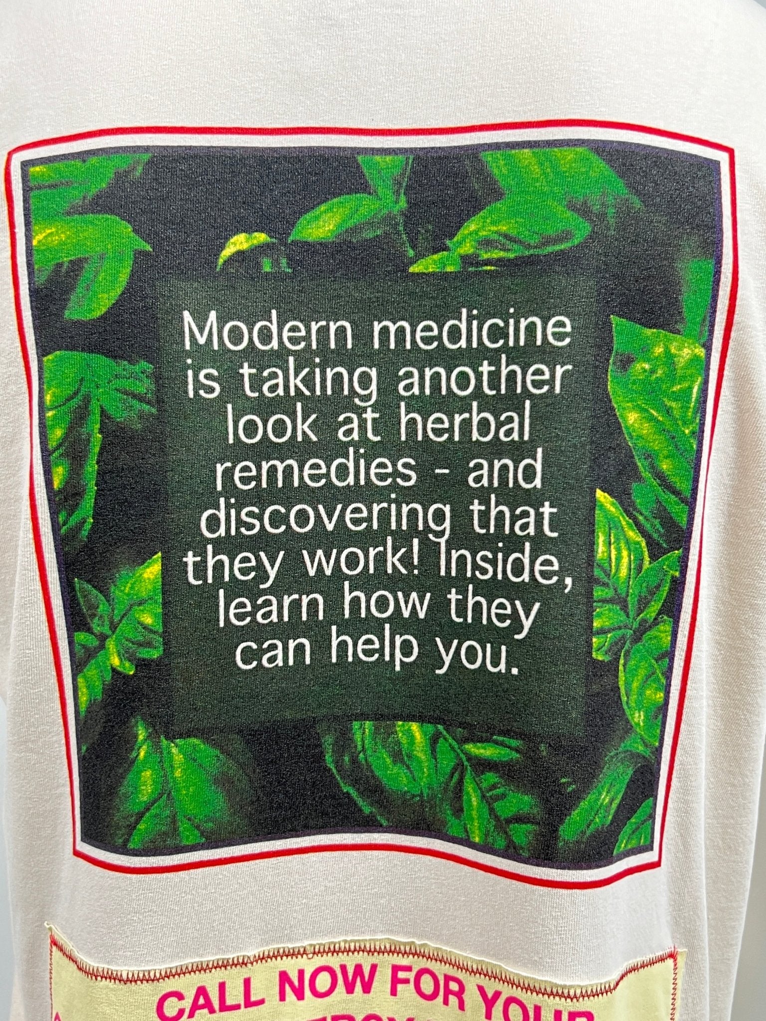 A poster with text: "Modern medicine is taking another look at herbal remedies - and discovering that they work! Inside, learn how they can help you." Background includes green leafy plants and an illustration of a beige CRTFD AYURVEDIC T-SHIRT NATURAL.