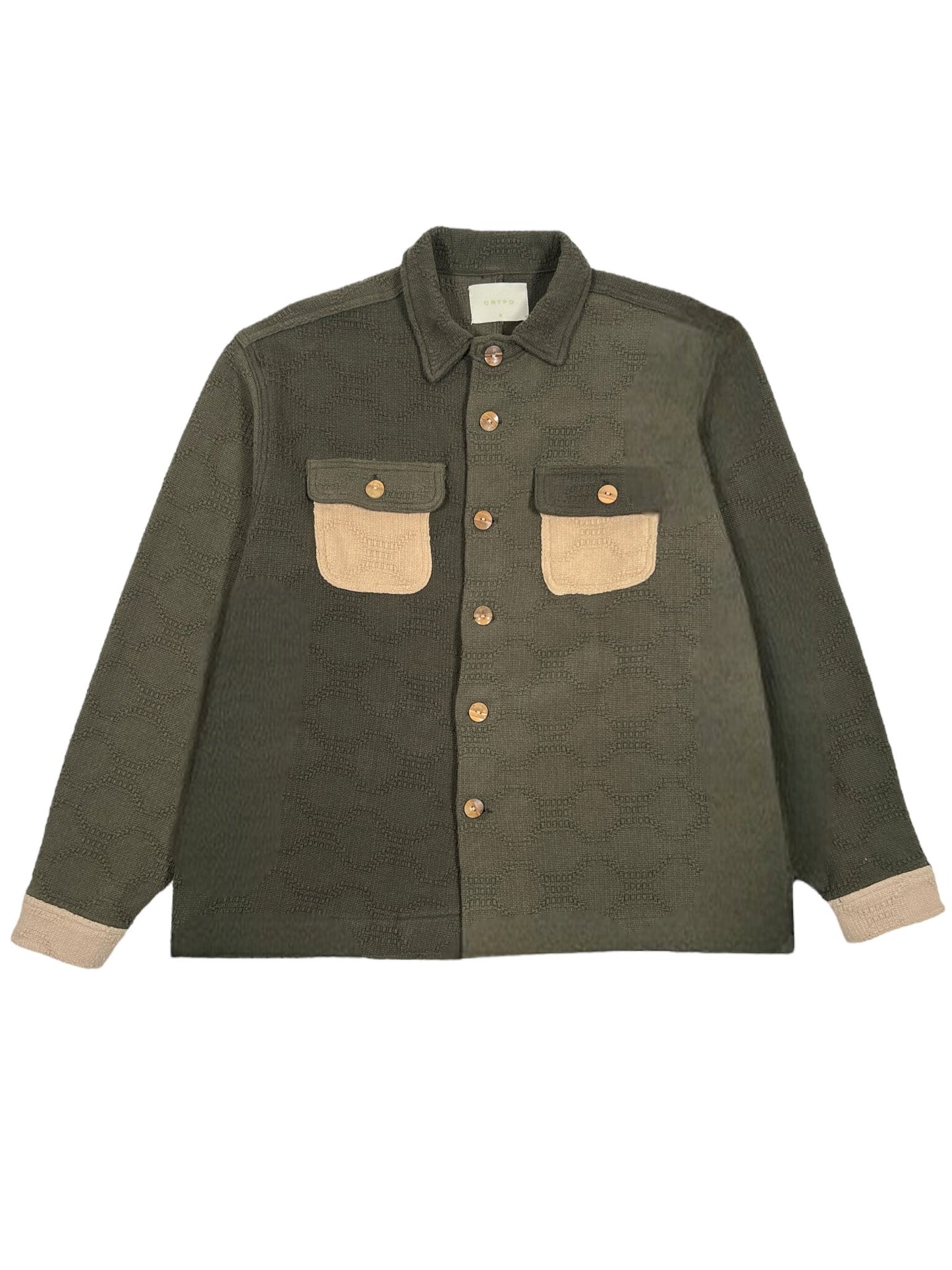 The CRTFD M51 COMBO SHIRT OLIVE by CRTFD is an olive green button-up jacket made from organic cotton, featuring beige pockets and sleeve cuffs along with a textured pattern.