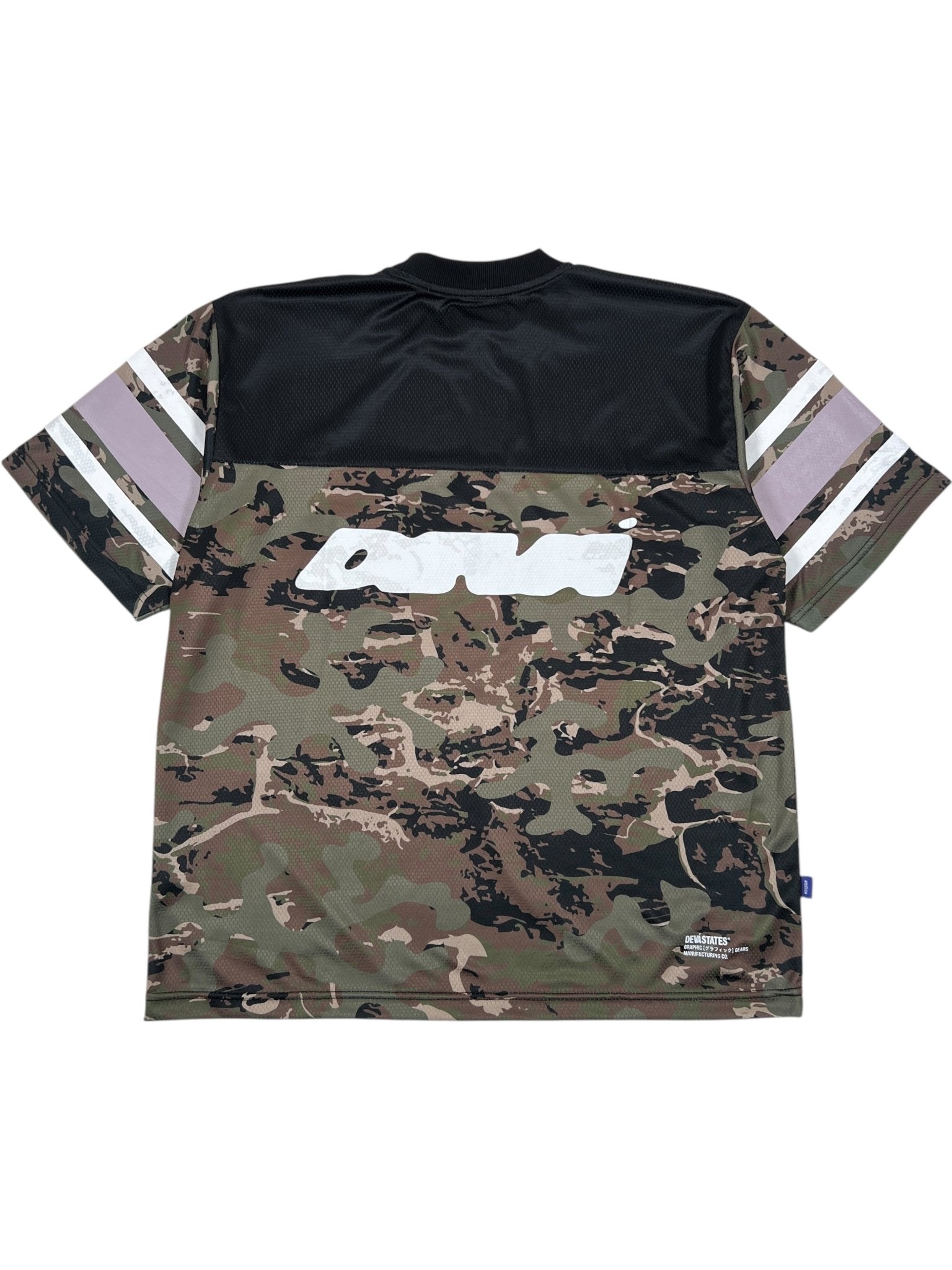 The DEVÁ STATES Deva'States Ballistic s/s Mesh Jersey Top Camo features black and camouflage color blocking, three white stripes on each sleeve, and a bold white Deva’States graphic logo on the back.