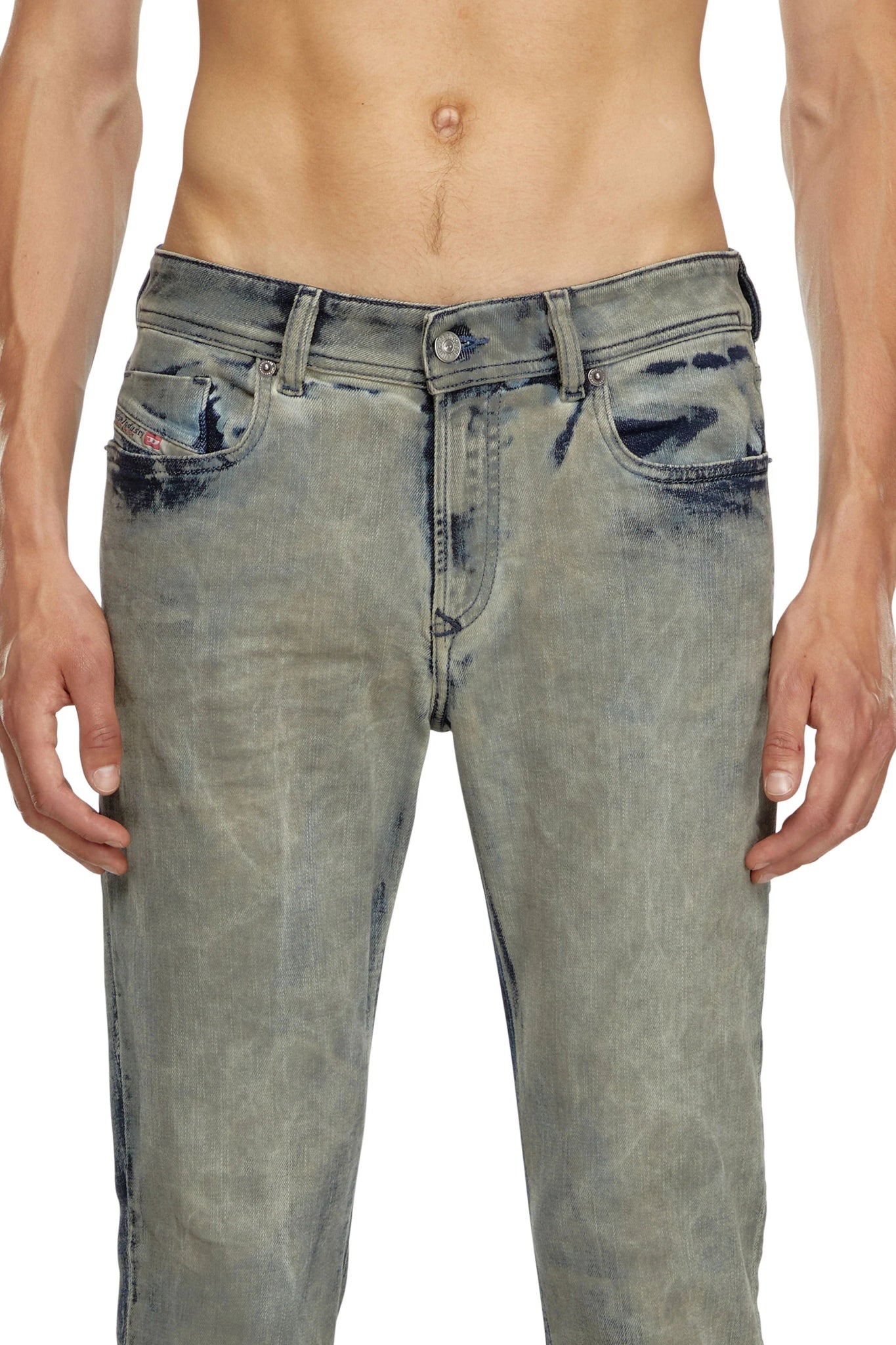 A shirtless individual wearing DIESEL's 1979 SLEENKER 68ND light blue stretch-denim distressed skinny jeans, with hands resting at their sides.