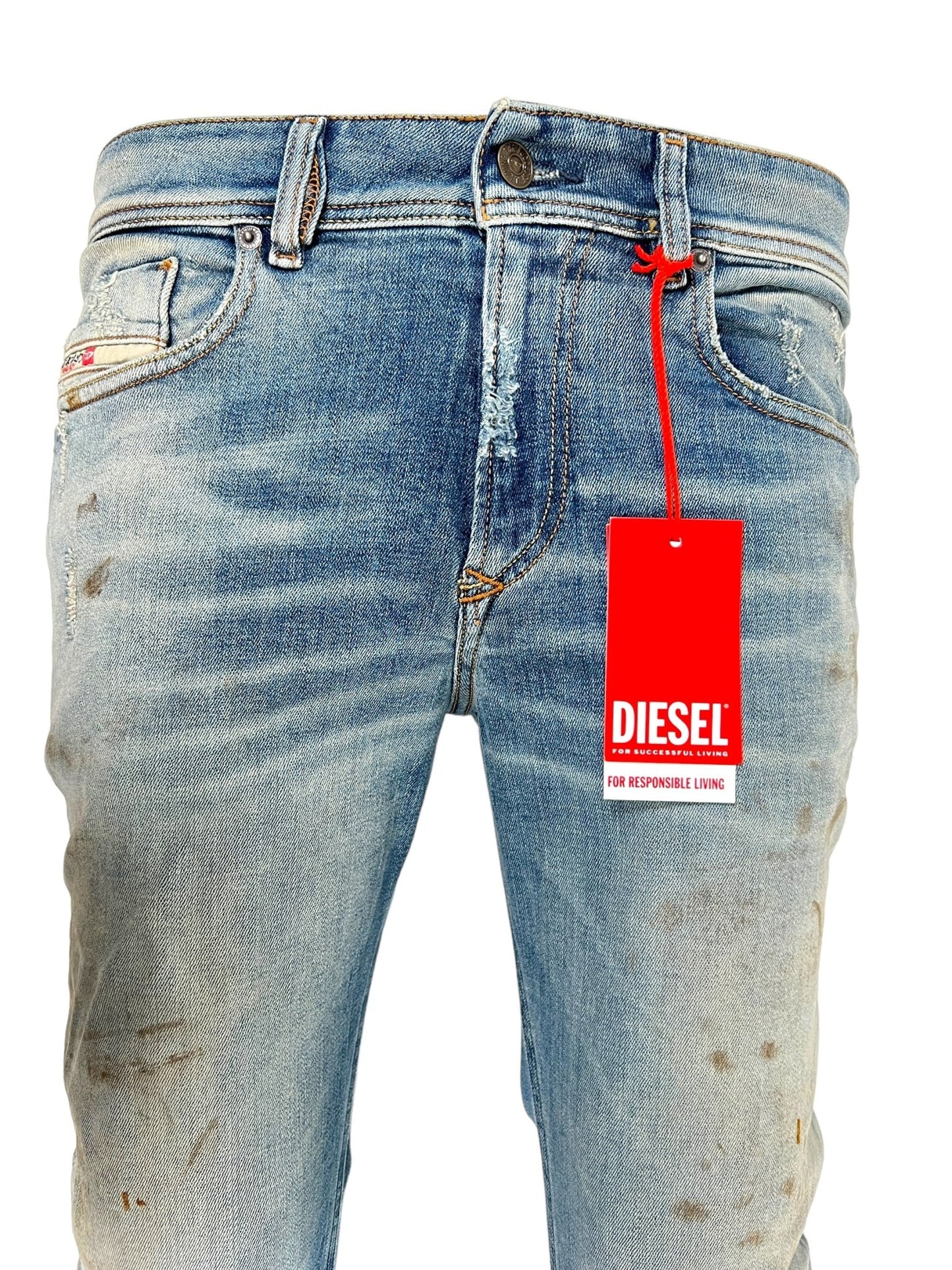 Close-up of the DIESEL 1979 SLEENKER 9J25 blue skinny jeans, featuring a red Diesel tag, with visible fading and slight distressing on the organic cotton denim.