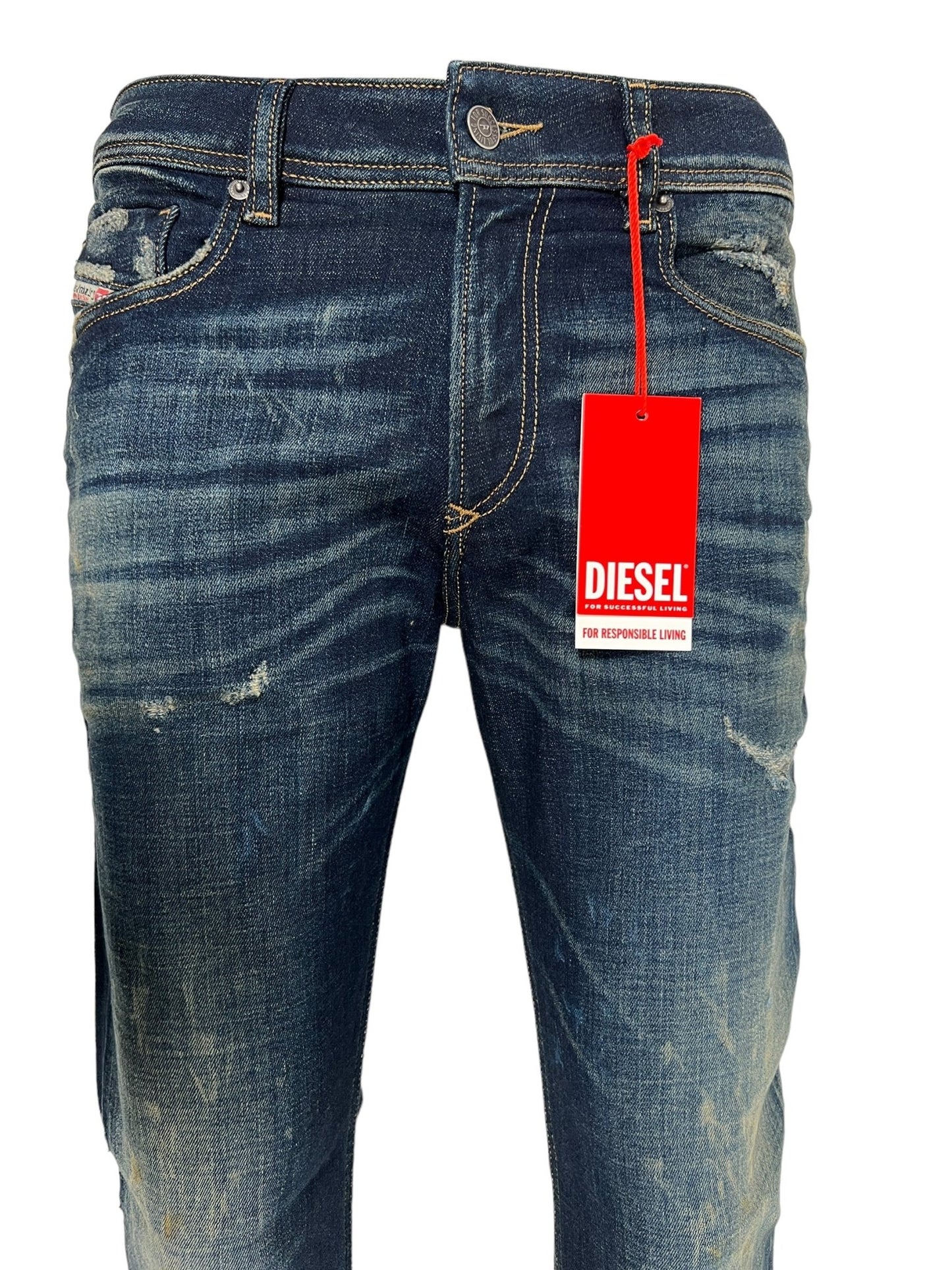 A pair of DIESEL 1979 SLEENKER 9J26 blue denim skinny jeans with visible whiskering and fading, featuring a red Diesel tag attached to the front belt loop and a zip fly.