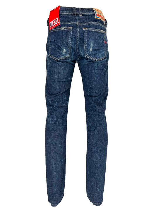 Back view of a pair of DIESEL 1979 SLEENKER 9J26 dark blue jeans with slight distressing and visible brand tags near the low-waist waistband.