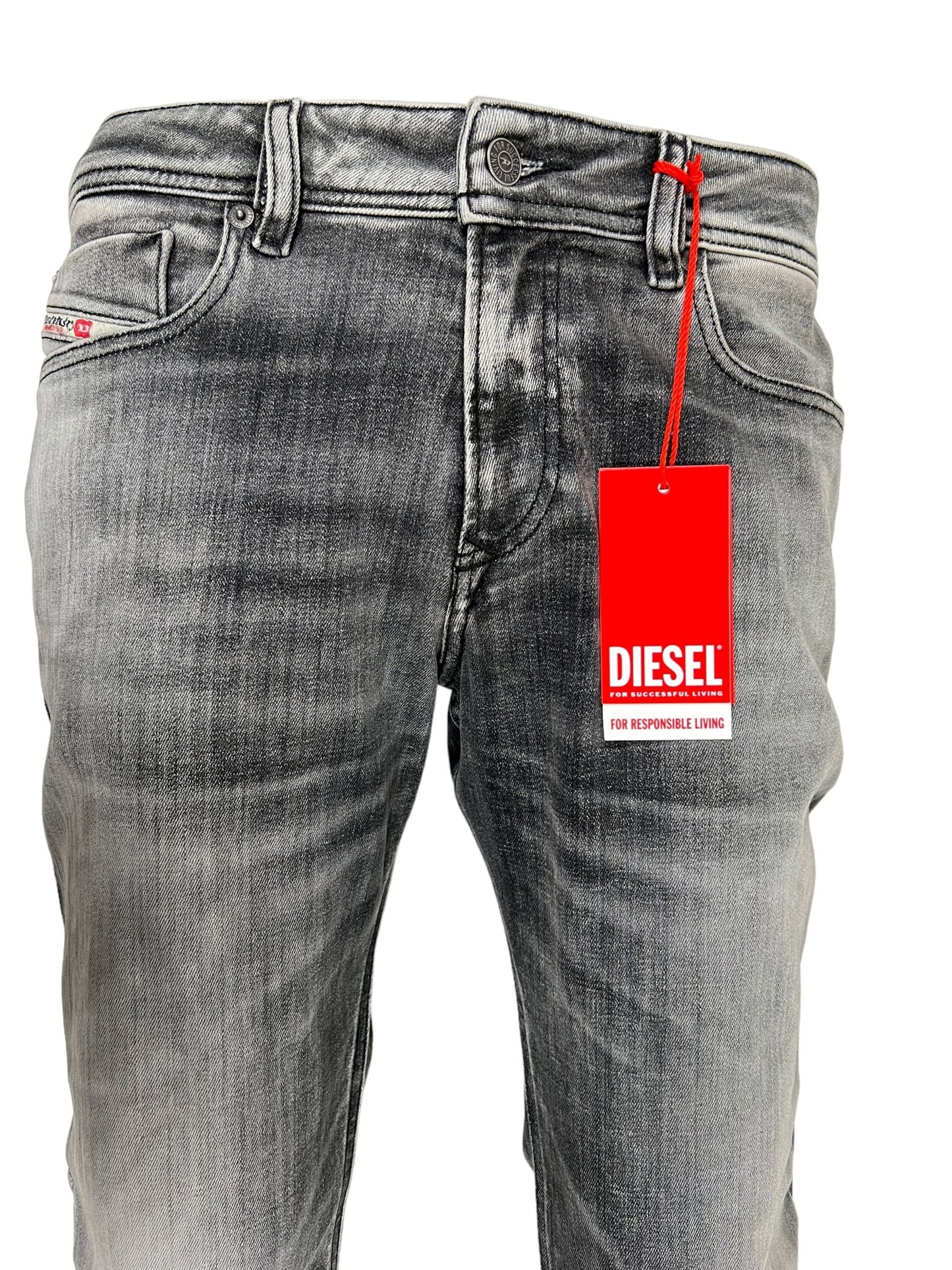 Close-up of DIESEL's 1979 Sleenker 9J28 jeans in faded grey, showcasing a red tag attached to the belt loop.