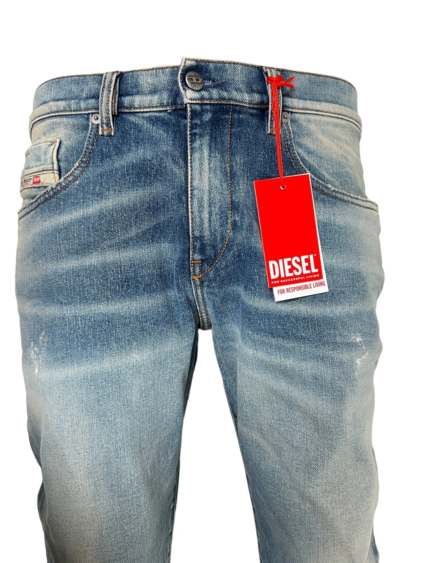 Close-up of a pair of DIESEL 2019 D-STRUKT 07V8 jeans with a red "DIESEL" tag attached to the belt loop. These blue slim jeans, crafted from organic cotton, feature a faded, distressed appearance along with visible button and zipper details.