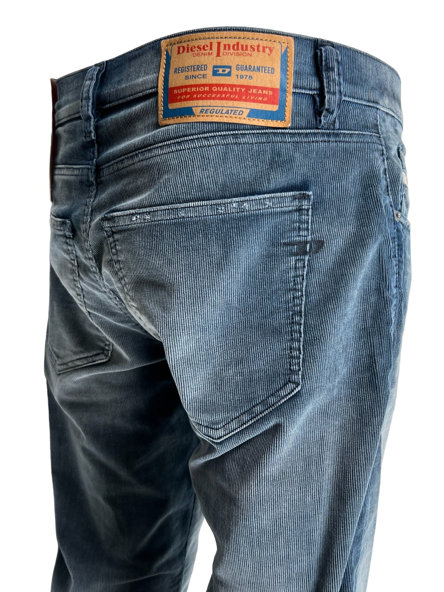 A person standing sideways wearing blue DIESEL 2019 D-STRUKT 68JF comfort denim jeans with a visible back pocket and brand patch.