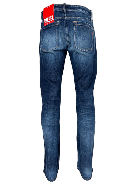 Rear view of a pair of blue Diesel D-Backler 9J56 bootcut jeans, highlighting visible pockets and featuring a red DIESEL tag on the waist, embodying the classic Diesel DNA.