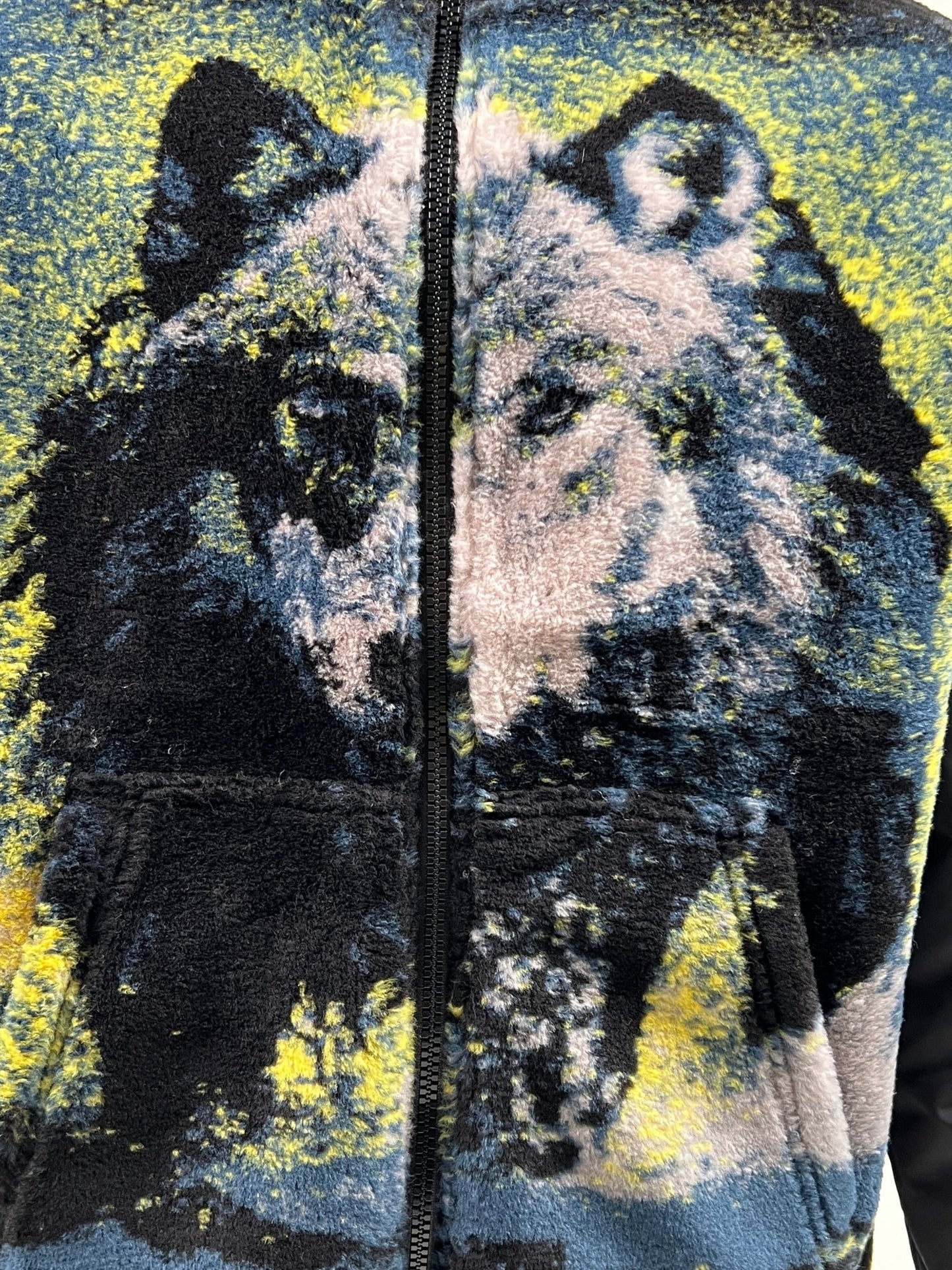 A close-up of the DIESEL S-BERTO-TEDDY BLACK zip-up sweater featuring a detailed image of a wolf on the front.