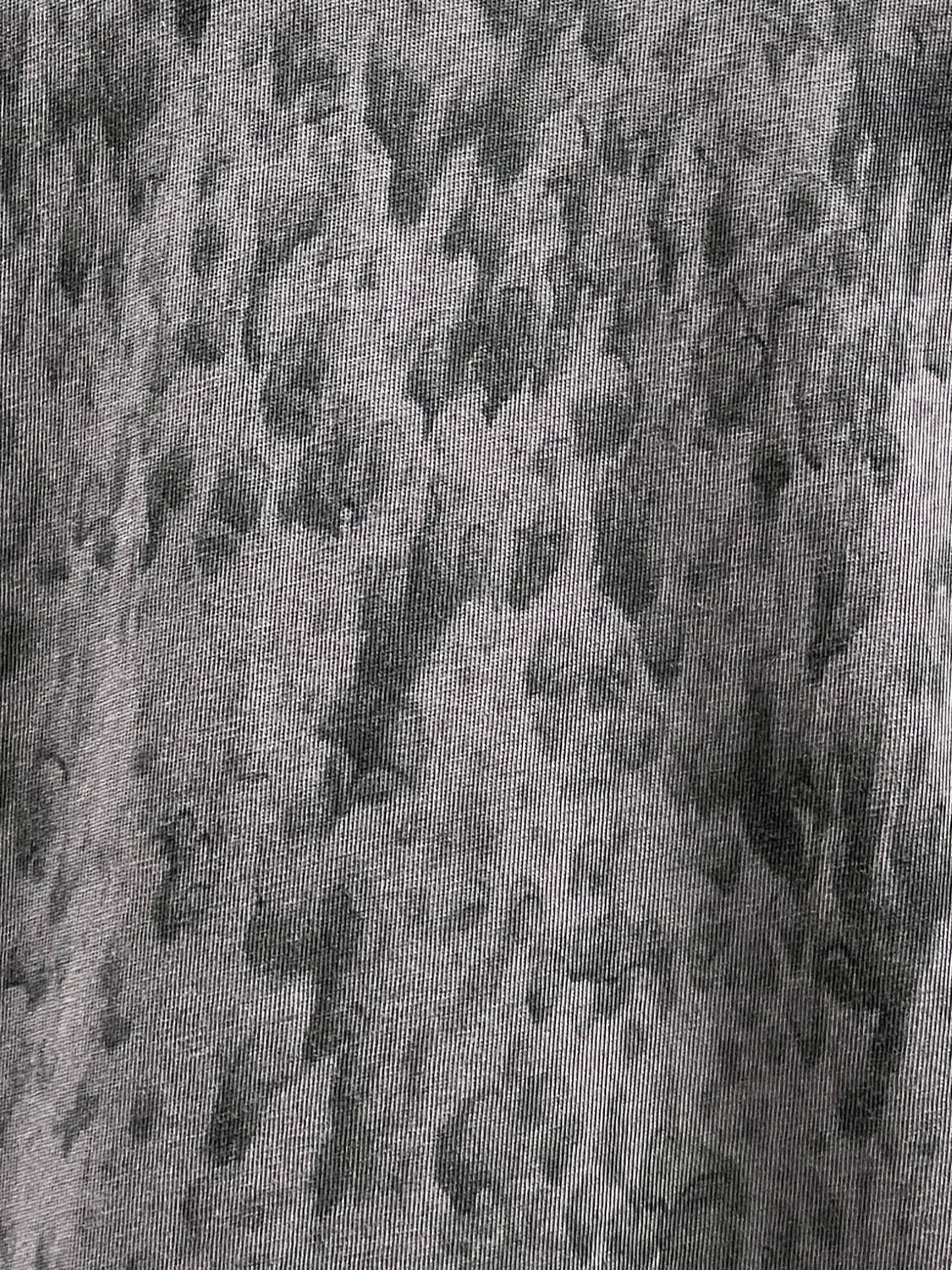 A close-up view of a 100% Cotton fabric with a gray, mottled pattern, reminiscent of your favorite DIESEL T-BOXT-K6 T-SHIRT BLACK.