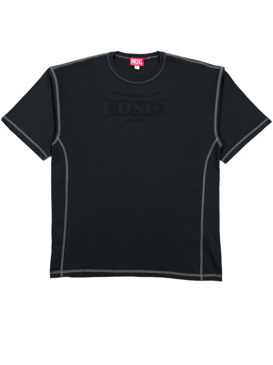 The DIESEL T-BOXT-SIDE T-Shirt Black is a plain black, short-sleeved tee made from 100% cotton. It features gray stitching details, a faint graphic on the front, and includes a subtle studded logo. The inside collar is labeled "Diesel.