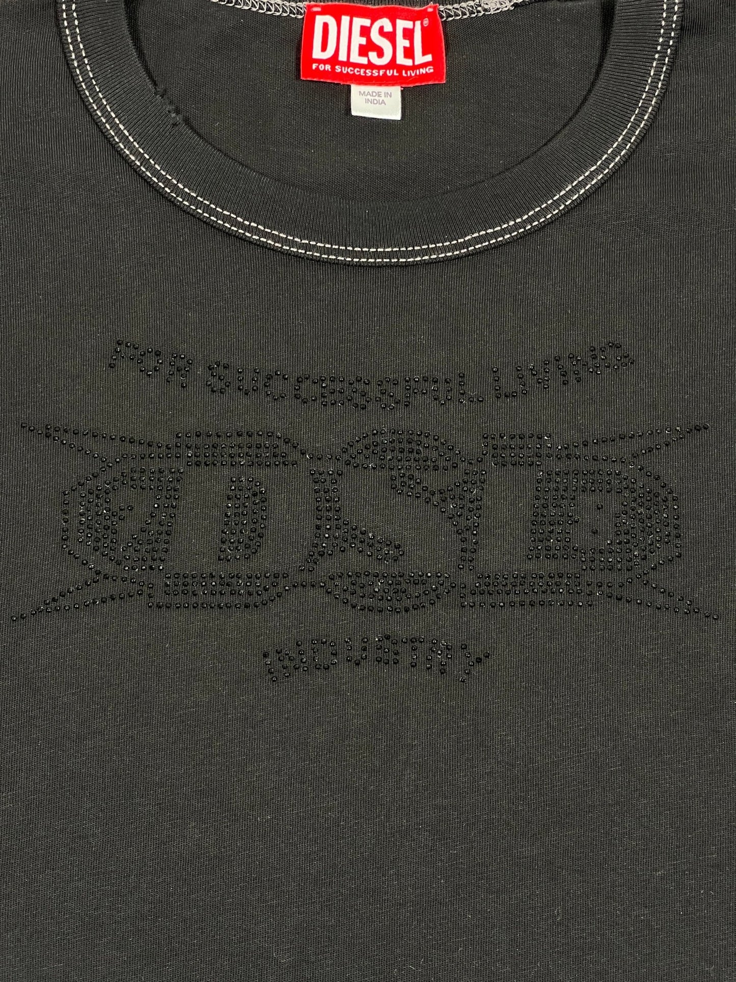 Close-up view of the DIESEL T-BOXT-SIDE T-SHIRT BLACK featuring the brand’s red tag on the collar and "For Successful Living" with a large studded "DSL" logo made of small embellishments on the front. Made from 100% cotton for ultimate comfort and durability.