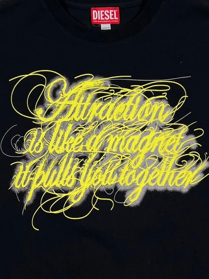 100% Cotton black DIESEL T-BUXT-N3 graphic t-shirt with yellow cursive graffiti-style writing that reads "attraction is like a magnet it pulls you together.