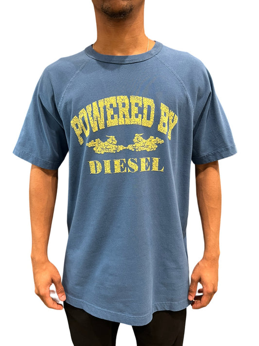 Man wearing a DIESEL T-RUST T-SHIRT TEAL with the text "powered by diesel" printed on the front.