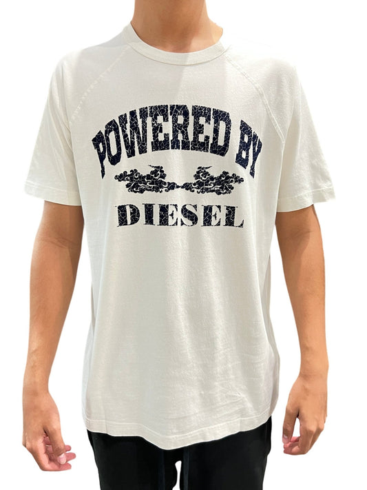 Person wearing a DIESEL T-RUST T-SHIRT WHITE with "powered by DIESEL" graphic printed on the front, combining style and comfort.