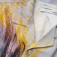 Close-up of a Domrebel Ascend Camp Collar Shirt Beige with an abstract design featuring yellow, red, and gray tones crafted from twill fabric. The label reads "DOM REBEL," showcasing original studio artworks.