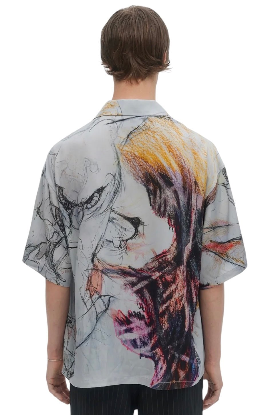 The individual with short hair is seen from the back wearing the eye-catching Domrebel Ascend Camp Collar Shirt in beige by DOM REBEL, which boasts abstract and colorful designs made from luxurious twill fabric.