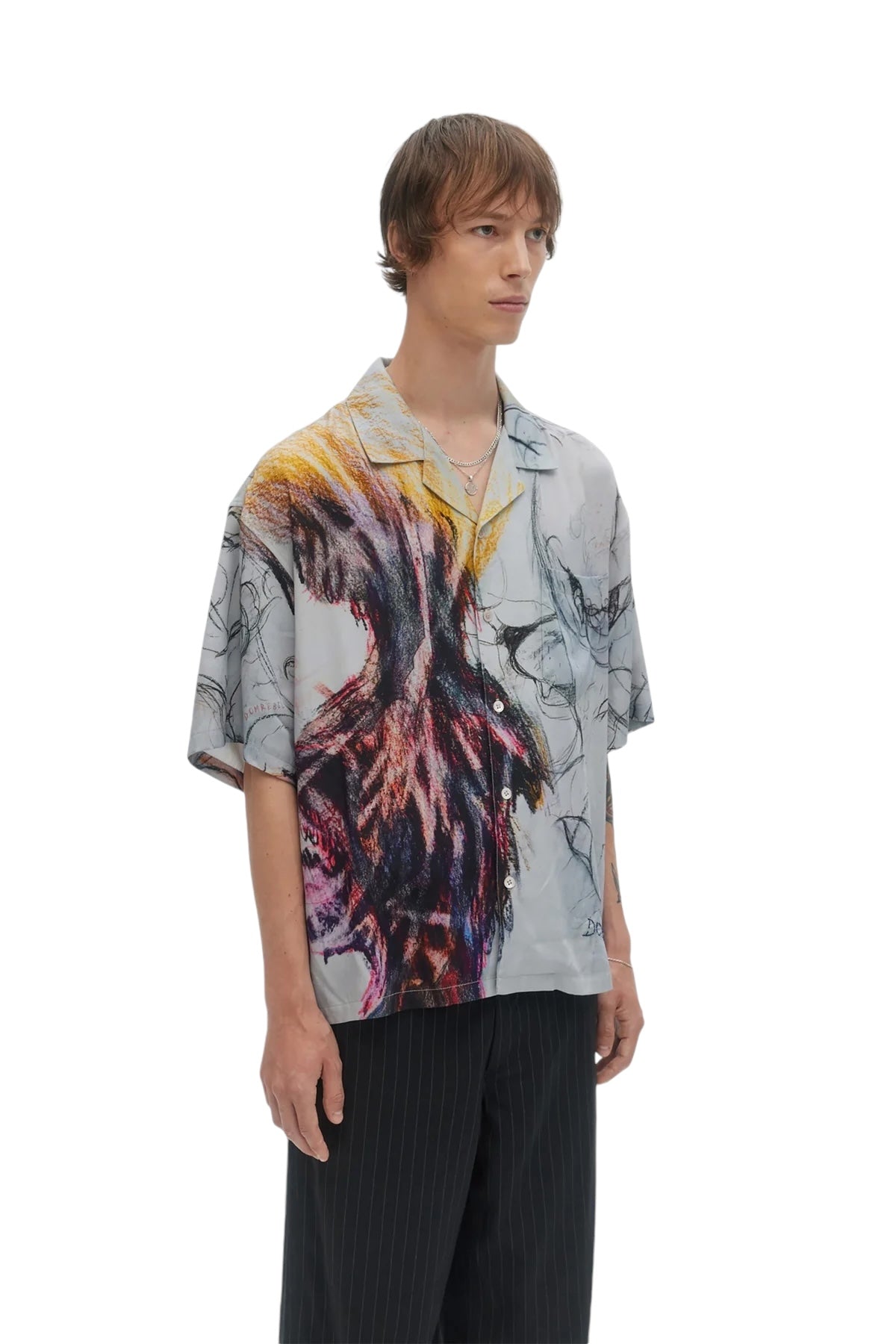 An individual wearing the Domrebel Ascend Camp Collar Shirt Beige from DOM REBEL, paired with dark pants, stands against a plain white background.