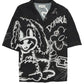 The Domrebel Chained Shirt Black by DOM REBEL showcases a full print of graffiti-style cartoons and script on a black short-sleeve button-up, made from a breathable rayon Tencel blend for both comfort and style.
