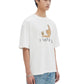 A person in a DOM REBEL Domrebel Friendly Ivory T-shirt, featuring a hand-drawn teddy bear, pairs it with blue jeans against a plain background.