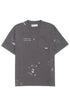 The Domrebel Atelier Pocket Tee Coal Paint by DOM REBEL features "D.R.S.M. ATELIER" text, a chest pocket, signature paint splatter design, and a small label.