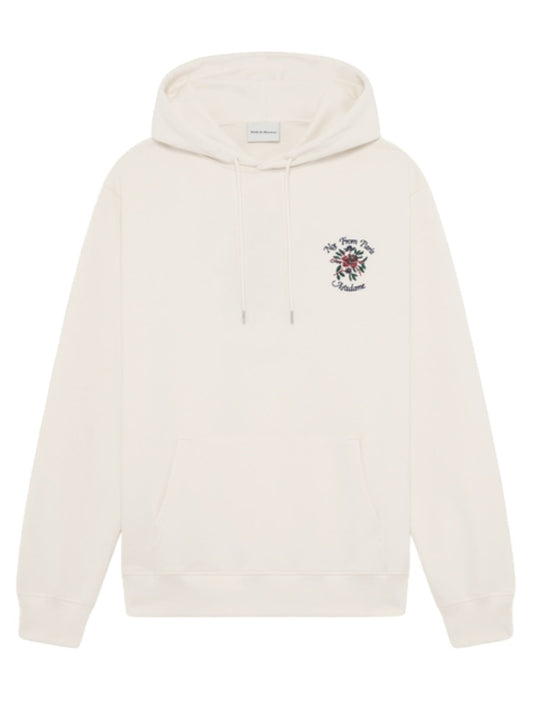 The DROLE DE MONSIEUR E-HO169-CO127-CM LE HOODIE FLEURS CREAM is a white French terry hoodie featuring a front pouch pocket and drawstrings, adorned with small floral Crillon embroidery and text on the left chest area. Made from 100% cotton to ensure maximum comfort.