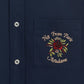 Close-up of the DROLE DE MONSIEUR E-SH189-PL149-NY LA CHEMISE NAVY, a navy long-sleeved shirt with white buttons and a chest patch pocket. The pocket features slogan embroidery with the text "Not From Paris Madame" and a red rose design.