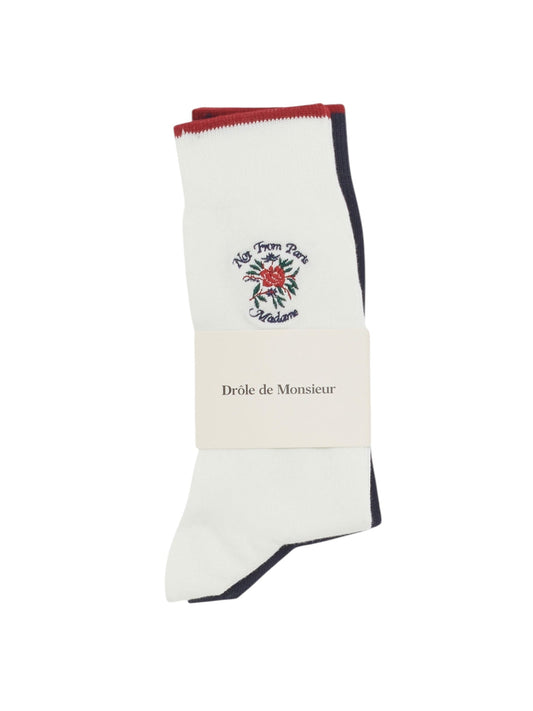 Drôle de Monsieur's La Chaussette Multi socks feature multi-colored floral embroidery and "Not From Paris Madame" text with red and black trim, elegantly wrapped in the brand's signature label.