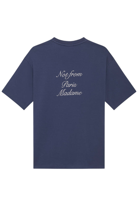 The DROLE DE MONSIEUR E-TS209-CO002-NY Le T-Shirt in navy, made in Portugal, features a dark background with white cursive text that reads "Not from Paris Madame.