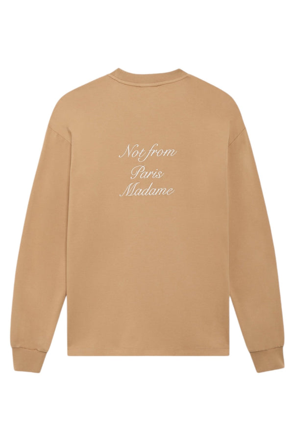 Beige sweatshirt from Drôle de Monsieur emblazoned with the phrase "Not from Paris Madame" in a stylish white calligraphy script on the back.