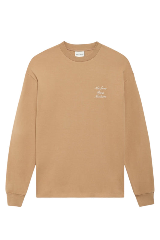 Beige long-sleeve Drôle de Monsieur E-TS220-Co002-LBN Le T-Shirt Brw with white embroidered calligraphy-style text "Not from Paris Madame" on the upper left chest area.