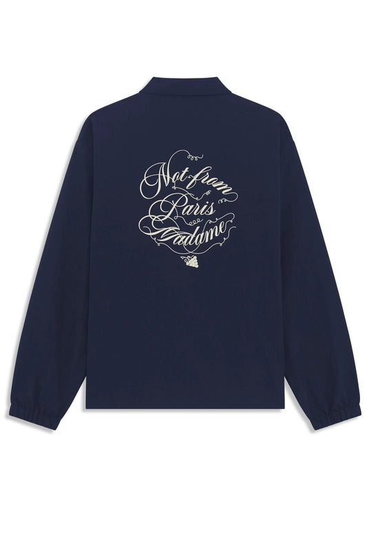 The Drôle de Monsieur F-JT209-PA012-Ny La Veste Navy features a loose fit with stylized white script on the back stating "Not from Paris Madame," inspired by the Slogan Vignes pattern, blending casual elegance with flair.