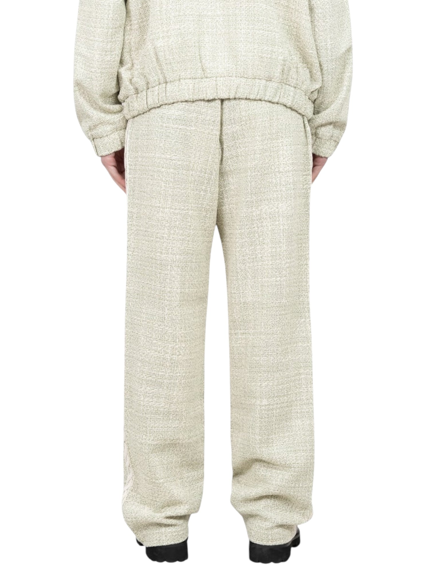 A person is seen from behind wearing Drôle de Monsieur G-BP183-CO186-LGN Tweed Pants in light green with an elasticated waist, paired with a matching jacket, standing with feet shoulder-width apart.